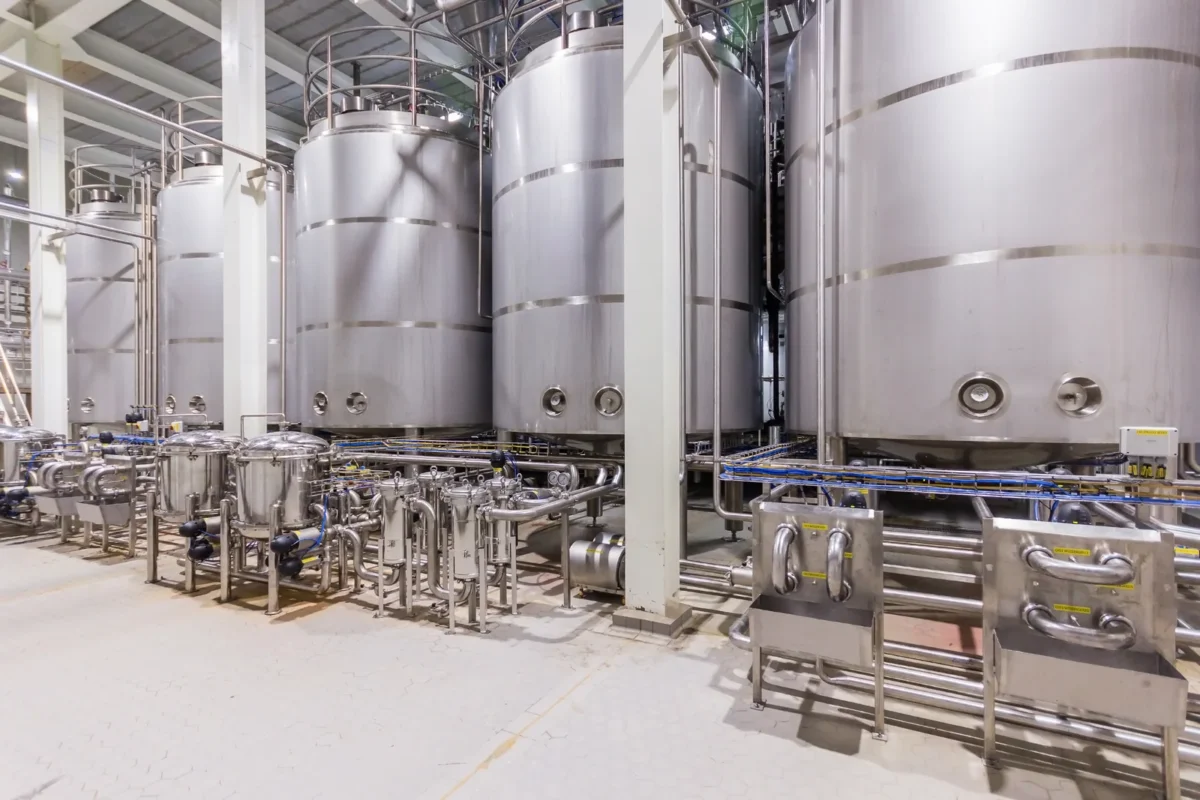 Stainless steel mixing vessels and pipework in a chemical processing facility.