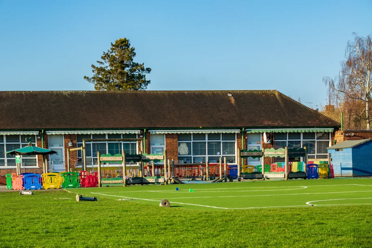 British junior school buildings and playing fields on a sunny day